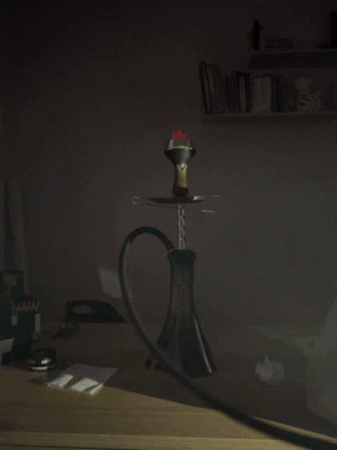 A Hookah With Smoke Coming Out Of It Is On A Table In The Dark GIF