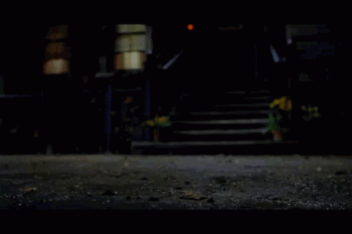 A House With Stairs And A Fence At Night GIF