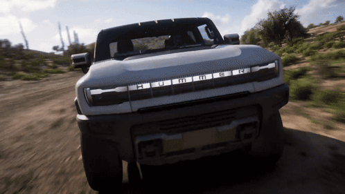 A Hummer Is Driving Down A Dirt Road In The Desert GIF