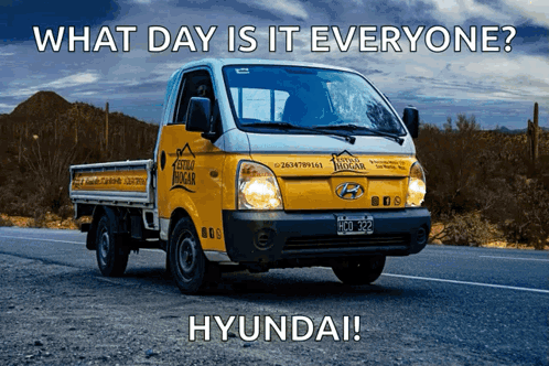 A Hyundai Truck Is Driving Down The Road GIF