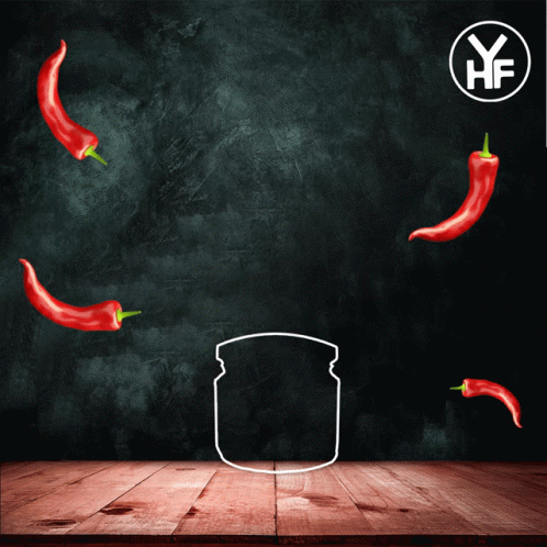 A Jar Of Chilli Paste Sits On A Wooden Table With Red Peppers Around It GIF