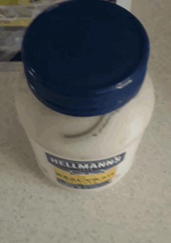 A Jar Of Hellmann 'S Mayonnaise Sits On A Table GIF