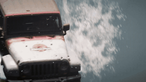 A Jeep With The Word Jurassic Park Painted On The Front GIF