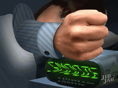 A Jib Jab Alarm Clock Is Being Turned On By A Man GIF
