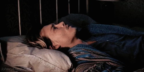 A Johnny Depp Gif Is Shown Of A Man Laying In A Bed GIF