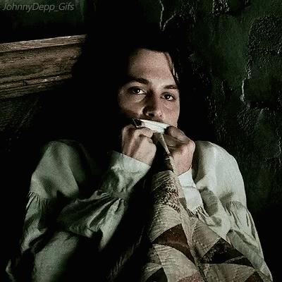 A Johnny Depp Gif Shows A Man Covering His Mouth With A Piece Of Cloth GIF