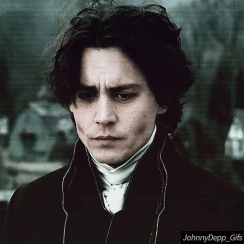 A Johnny Depp Gif With A Man In A Suit And Tie GIF