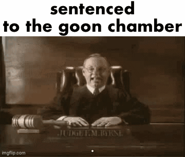 A Judge Is Sitting At A Desk In A Courtroom Holding A Gavel And A Book . GIF
