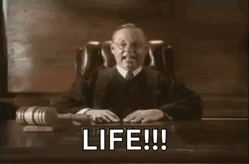 A Judge Is Sitting At A Desk With A Gavel And The Words Life Written On It GIF
