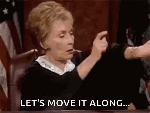 A Judge Is Sitting At A Table In A Courtroom Giving A Thumbs Down Sign . GIF