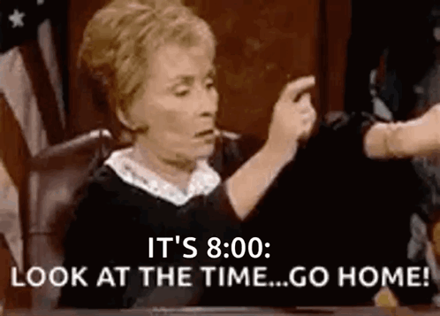 A Judge Is Sitting At A Table In A Courtroom Pointing At Someone . GIF