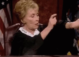 Judge Making Funny Face In Court With American Flag GIF