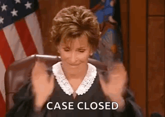 A Judge Is Sitting In A Courtroom With Her Hands In The Air And The Words `` Case Closed '' . GIF