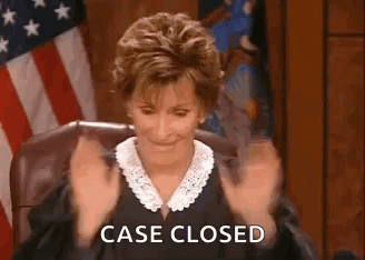 A Judge Is Sitting In A Courtroom With Her Hands In The Air And The Words `` Case Closed '' Written On The Screen . GIF