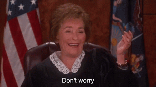A Judge Is Smiling While Sitting In Front Of An American Flag And Saying `` Do N't Worry '' . GIF