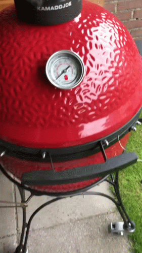 A Kamado Joe Grill With A Thermometer On Top GIF