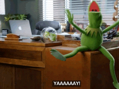 A Kermit The Frog Is Sitting On A Desk And Says Yaaaaay GIF