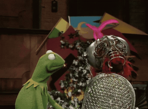 A Kermit The Frog Is Standing Next To A Knight GIF