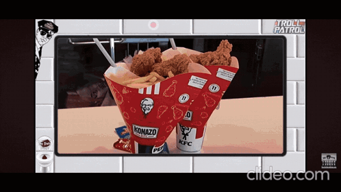 a kfc cone with fried chicken and french fries on a table