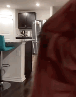 A Kitchen With A Stainless Steel Refrigerator And A Blue Bar Stool GIF