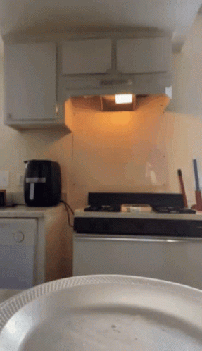 A Kitchen With A Toaster And A Plate GIF