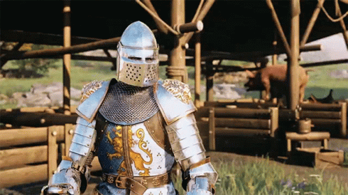 A Knight In Armor Is Standing In Front Of A Building GIF
