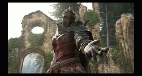 A Knight In Armor Is Standing In Front Of A Ruined Building With His Hand Out . GIF