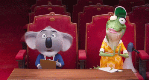 A Koala Bear And A Lizard Sit At A Table In A Theater GIF
