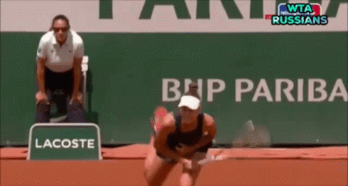 A Lacoste Sign Is In Front Of A Bnp Pariba Sign GIF