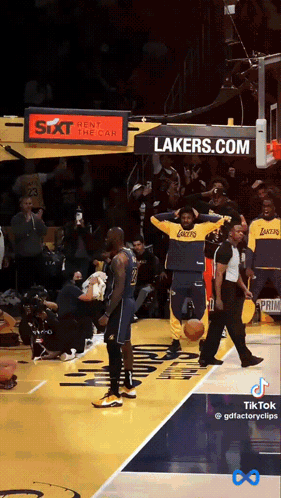 a lakers basketball player stands on the court