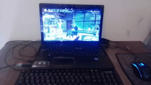 A Laptop Is Open To A Video Game Called Aliens GIF