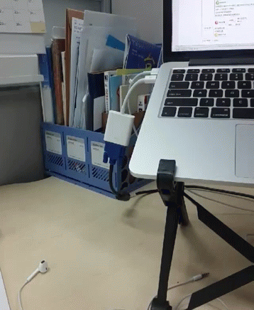 A Laptop Sits On A Desk Next To A Binder That Has A Sticker On It That Says ' A ' On It GIF