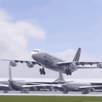 A Large Airplane Is Taking Off From A Runway GIF