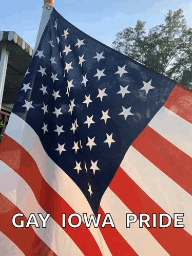 a large american flag with the words gay iowa pride above it