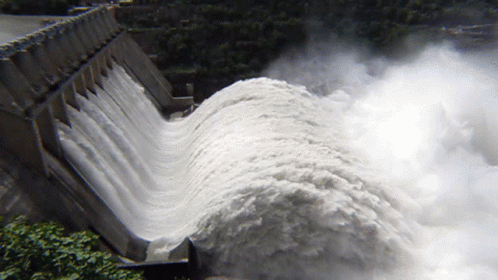 A Large Amount Of Water Is Coming Out Of A Large Dam GIF