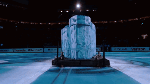 A Large Block Of Ice Sits In The Middle Of An Ice Rink Sponsored By Verizon And Oakland GIF