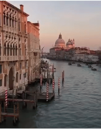 A Large Body Of Water Surrounded By Buildings And A Dome GIF