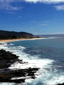 A Large Body Of Water Surrounded By Rocks And Mountains GIF