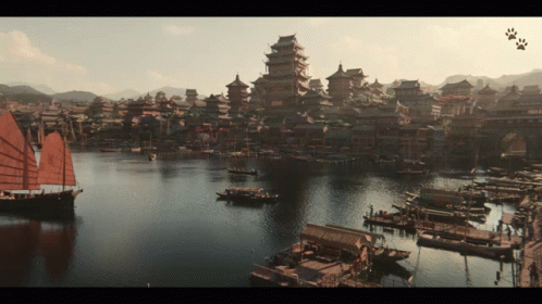a large body of water with boats in it and a city in the background