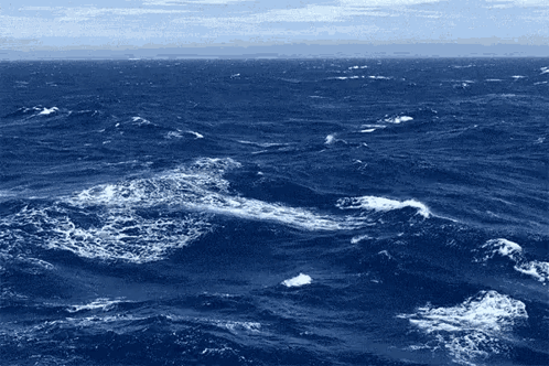 A Large Body Of Water With Waves And Foam Coming Out Of It GIF