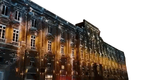 a large building is lit up at night with a white background
