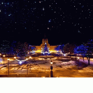 A Large Building Is Lit Up With Christmas Lights GIF