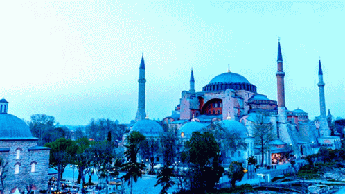 A Large Building With A Dome And A Few Minaret 'S In Front Of It GIF