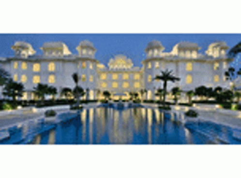 A Large Building With A Swimming Pool In Front Of It GIF