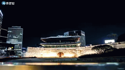 A Large Building With The Word Namdaemun On The Bottom GIF