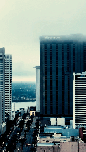 A Large Building With The Word Sheraton On The Top GIF