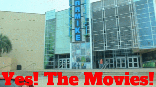 A Large Building With The Words Yes The Movies Written On It GIF
