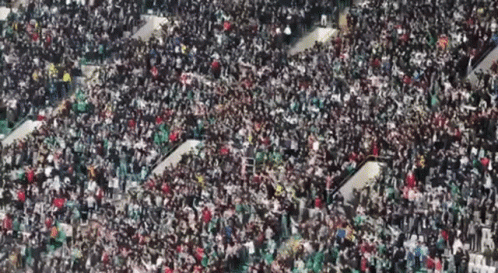 A Large Crowd Of People Are Gathered In A Large Stadium GIF