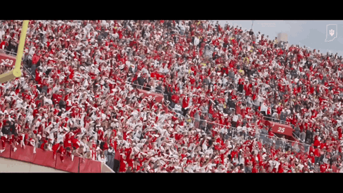 A Large Crowd Of People In A Stadium With The Number 25 On The Bleachers GIF
