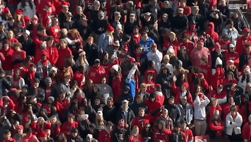 A Large Crowd Of People Wearing Red Shirts With Espn On The Bottom Left GIF